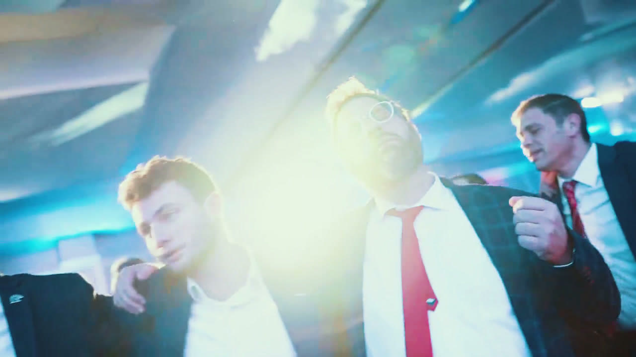 A group of men standing arm in arm and singing together at an MDY event