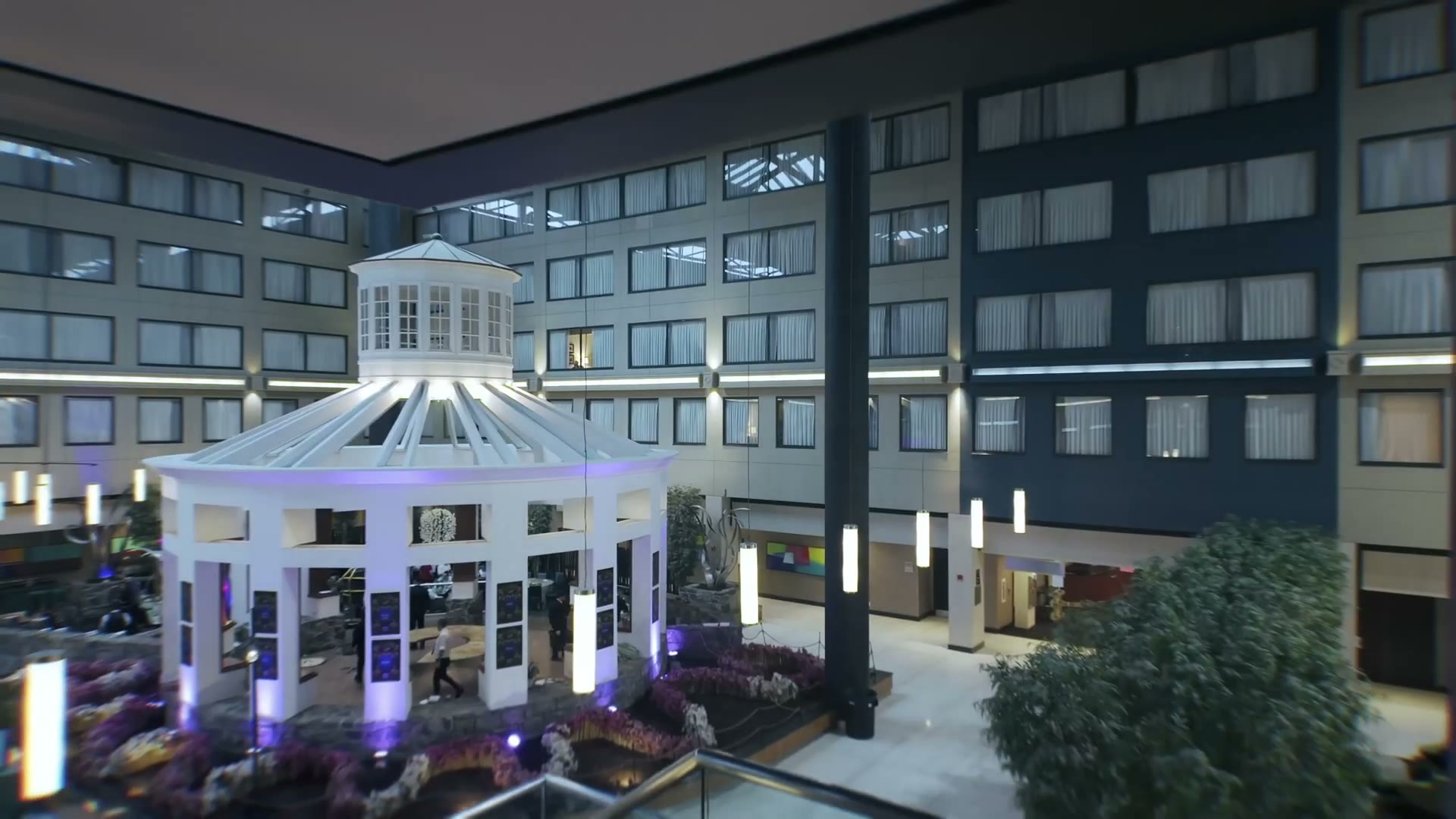 The hotel atrium the morning after, the gazebo lit and nobody in it