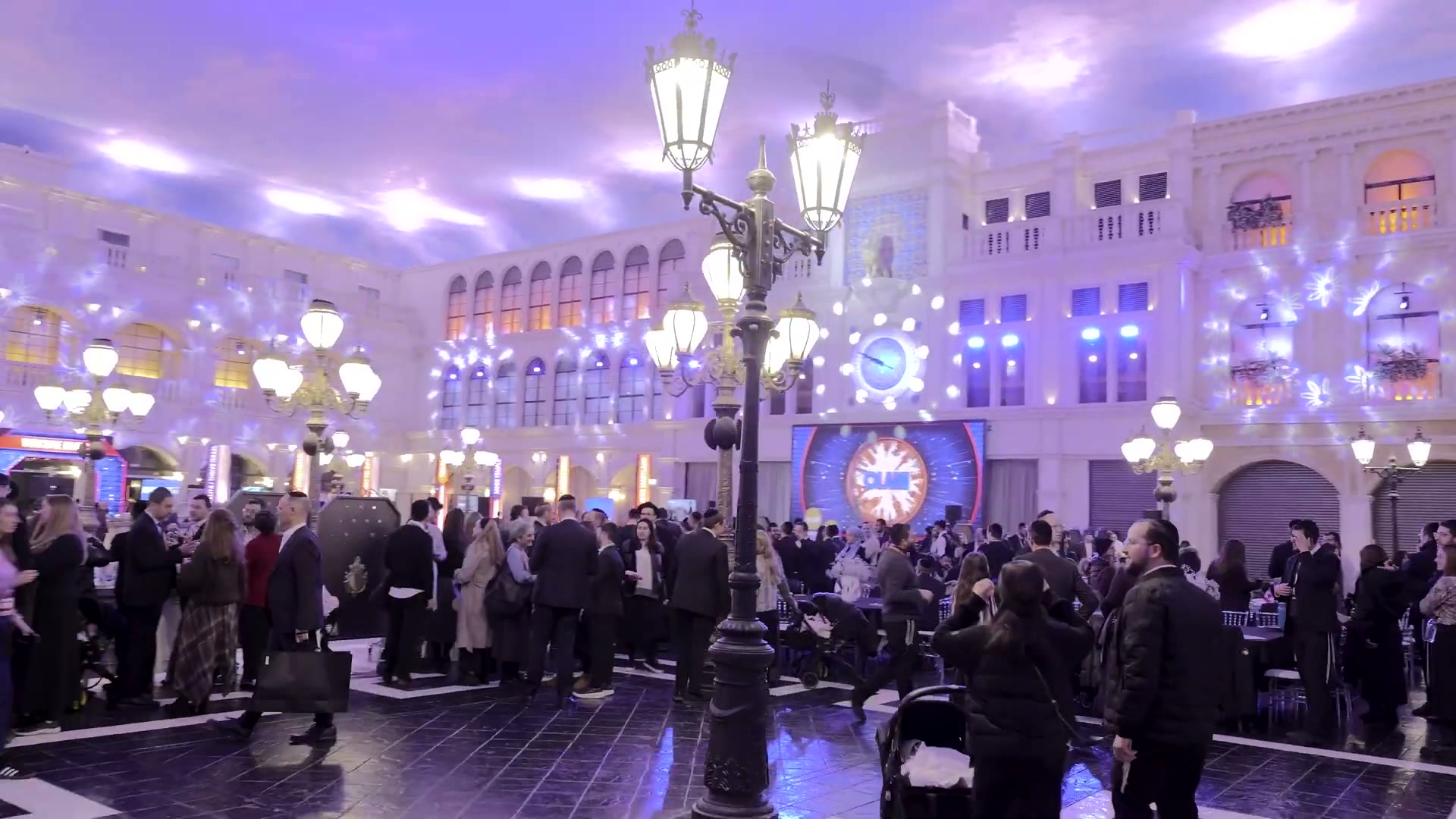 The Olami atrium at the Venetian, full, lit purple, the crowd on the floor